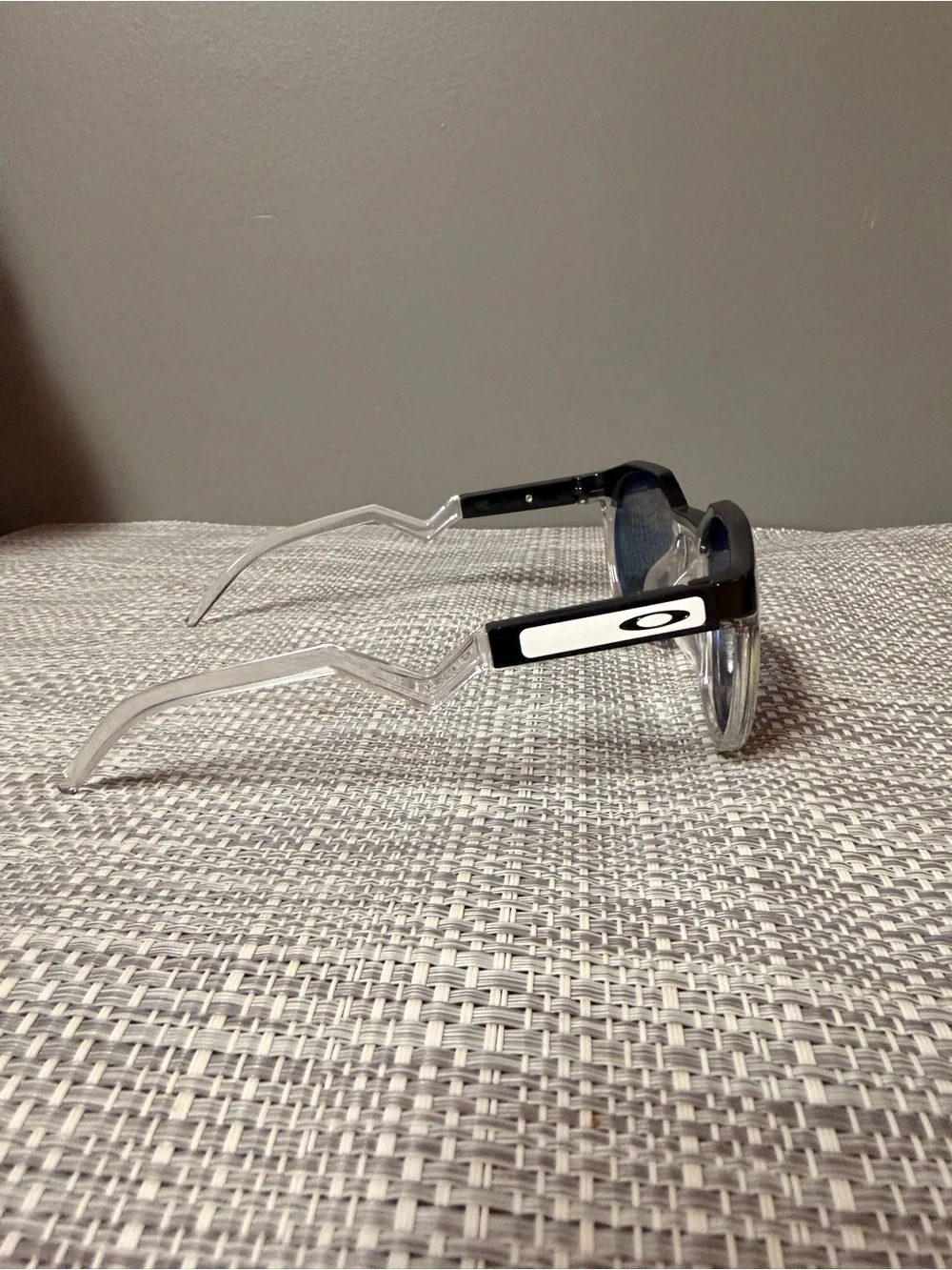 Oakley Clear Frame Sunglasses with Black Temples and Dark Lenses